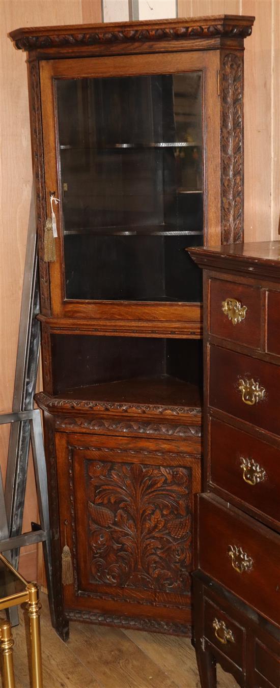 A late Victorian carved oak standing corner cupboard W.72cm